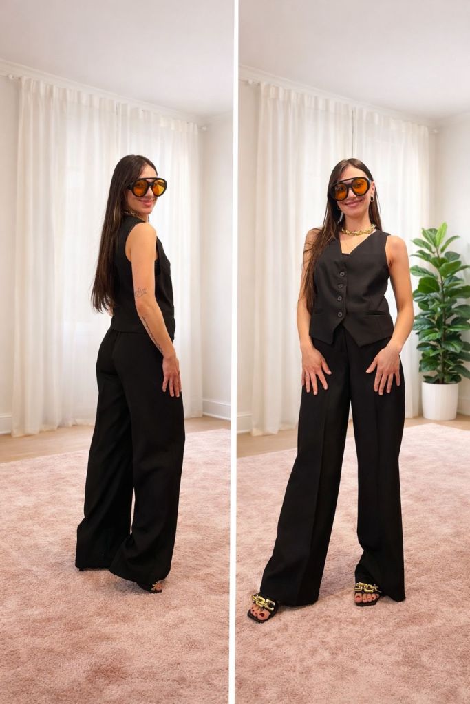 Una donna in abbigliamento elegante nero, indossa occhiali da sole grandi e posa con un sorriso. L'immagine mostra diversi angoli del suo outfit, con un gilet e pantaloni larghi, mentre il fondo è un ambiente luminoso con tende bianche e una pianta decorativa.